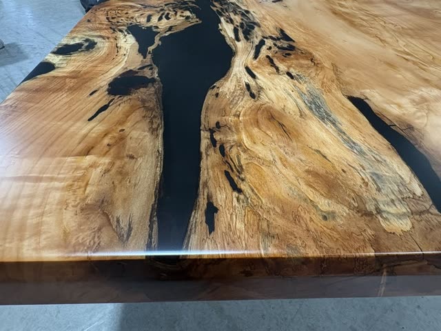 The black epoxy fill running through the figured willow grain across the top
